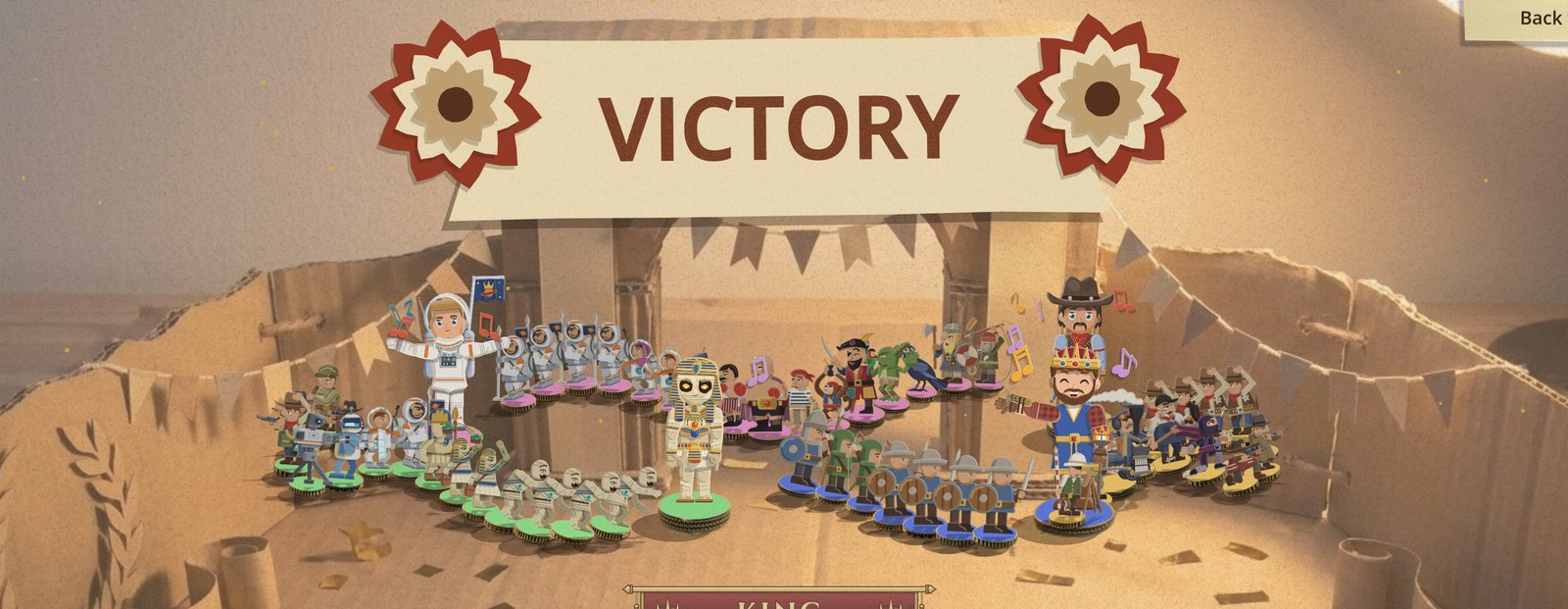 The co-op victory conga: under the VICTORY banner, four warlords each lead their own army in a weaving line across the cardboard floor