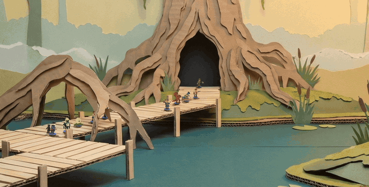 The Rootmire on the Continue menu: standees walk along a wooden boardwalk on stilts over black-green water, under a great cardboard root that arches over the walk, toward the door in the hollow at the foot of the giant tree
