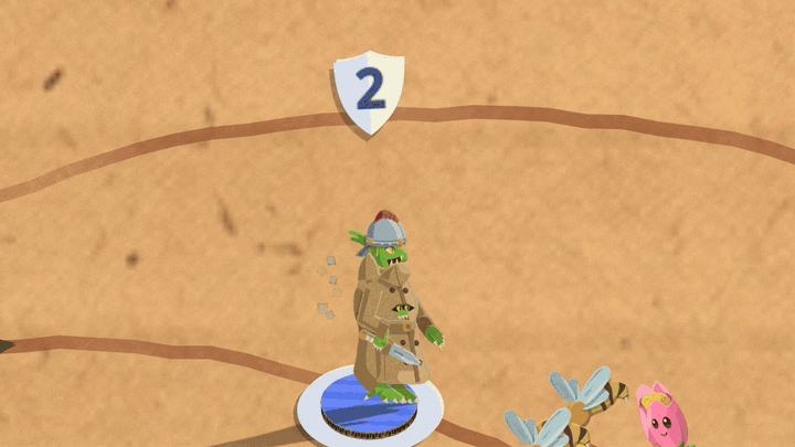 A tall belted trenchcoat with a goblin face in the collar and a helmet on top stands on a blue base with a shield badge reading 2 over it. Bees and flowers attack it. Each hit pops the word Invulnerable and a green goblin springs out of the coat, until three goblins stand in a pile where the coat was