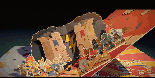 The opening film's pop-up page turns to a stepped red and gold pyramid under a huge gold sunburst. Townsfolk stand up along the front with their arms raised